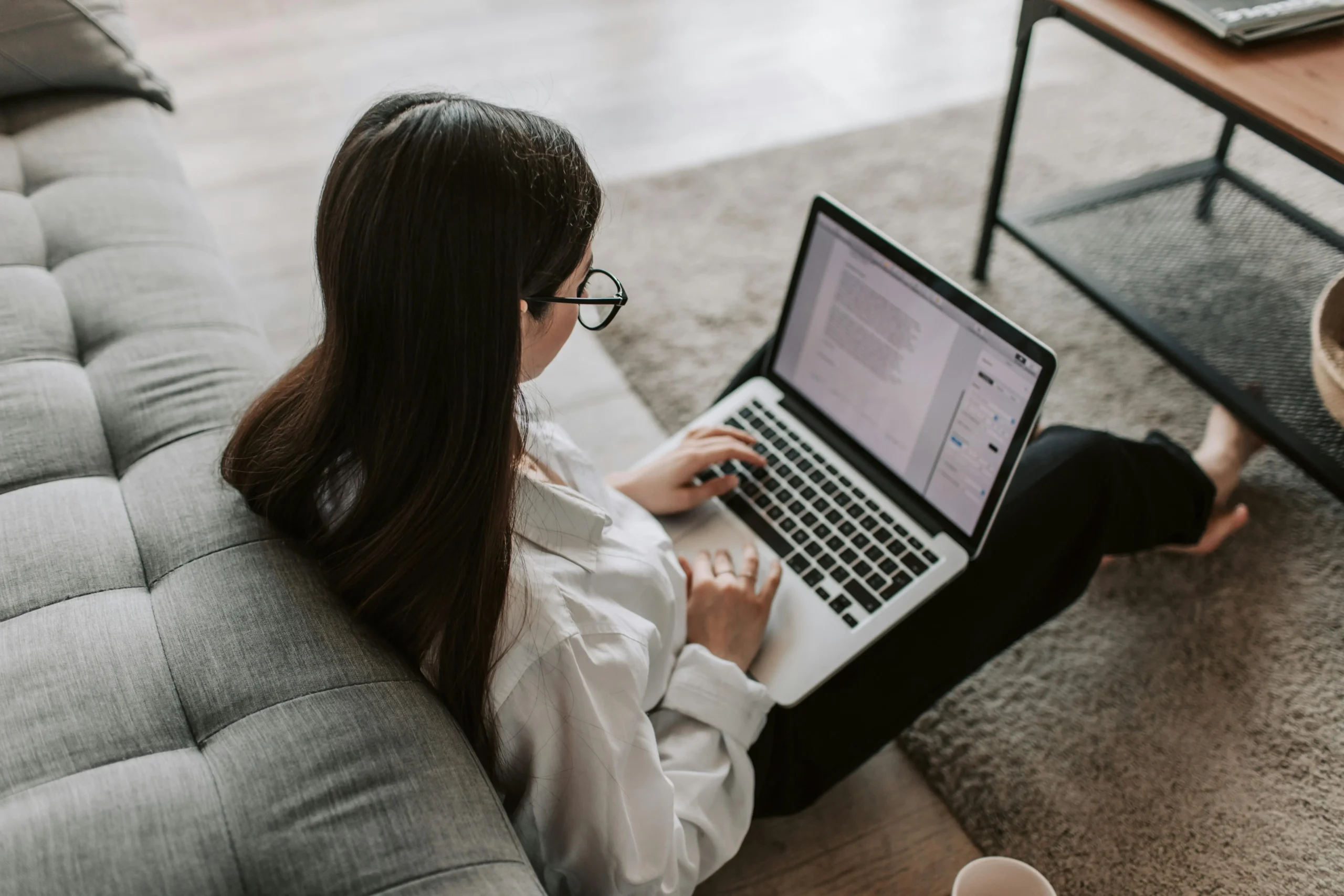 a girl is working with her laptop